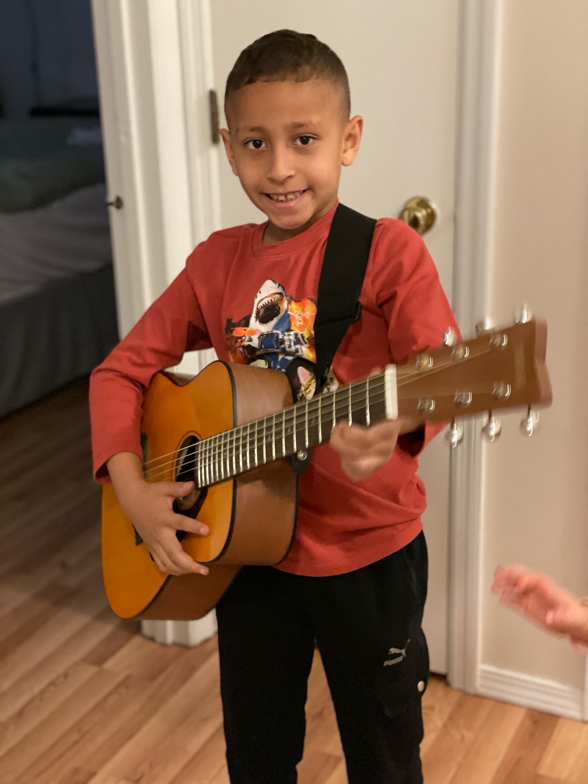 Leonardo playing guitar at home
