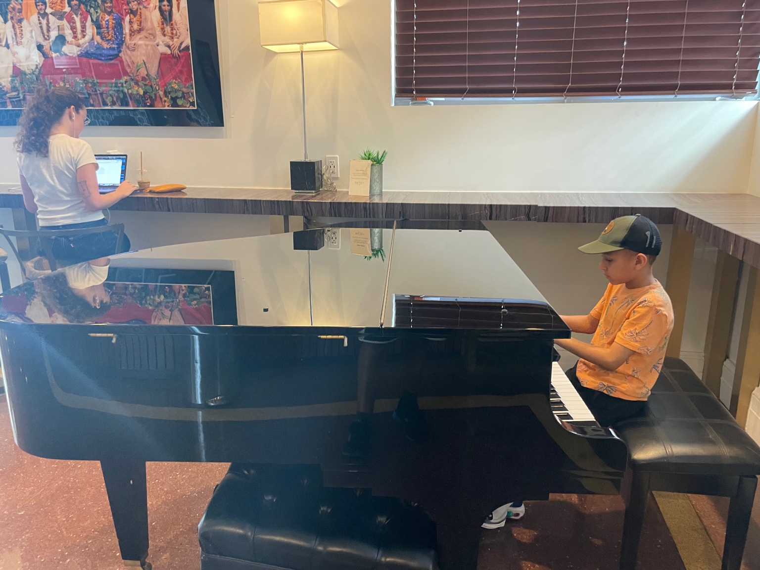 Leonardo playing piano in a hotel lobby